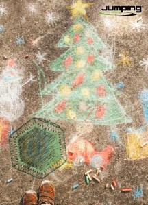 Boy drawing Christmas tree and decorations on the street.